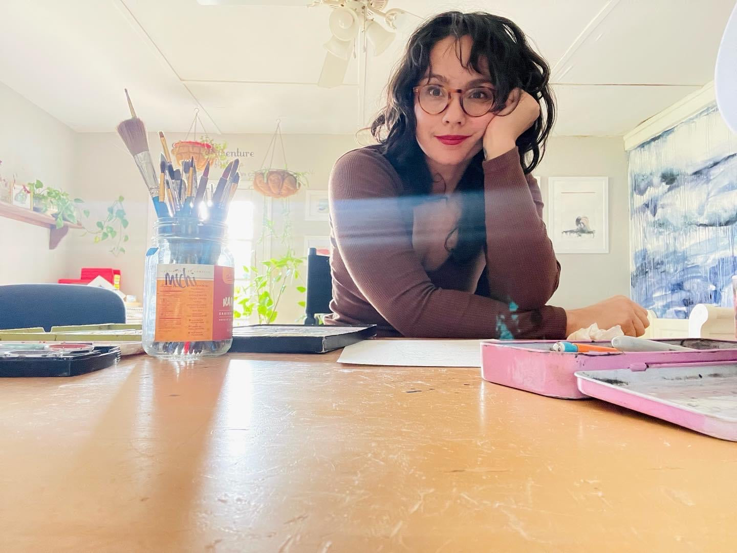 Woman artiest setting at a desk